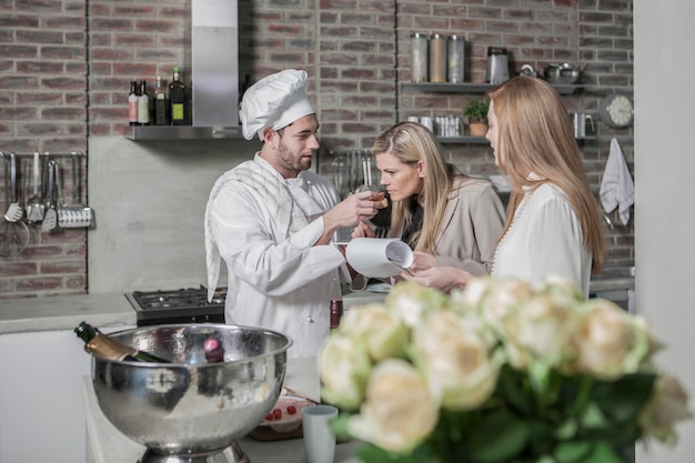 Chef with two women in kitchen