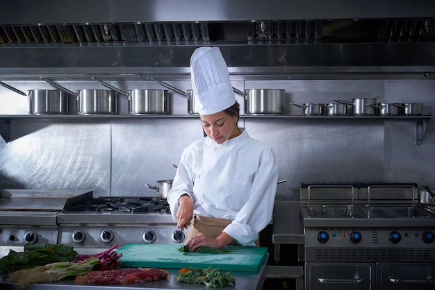 Chef woman portrait cutting at kitchen