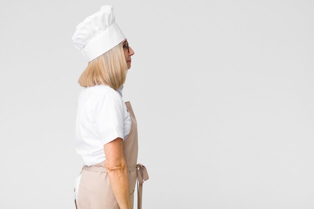 chef woman on profile view looking ahead thinking