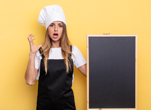 Chef woman screaming with hands up in the air blackboard menu concept