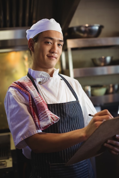 Chef writing on a clipboard