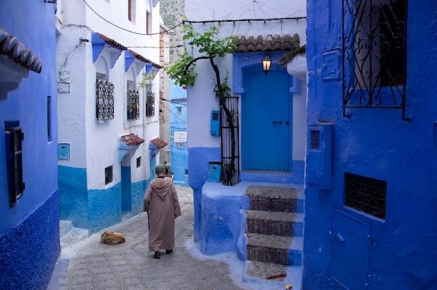 Chefchaouen, Morocco. Local man in traditional clothes is going on the street of Chefchaouen