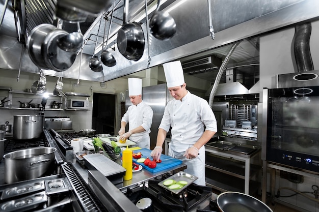 Chefs prepare meals in the kitchen