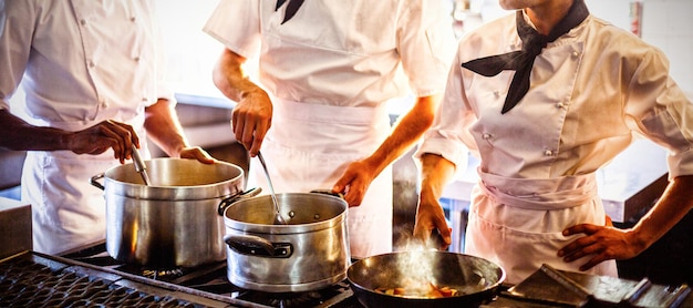 Chefs preparing food at stove