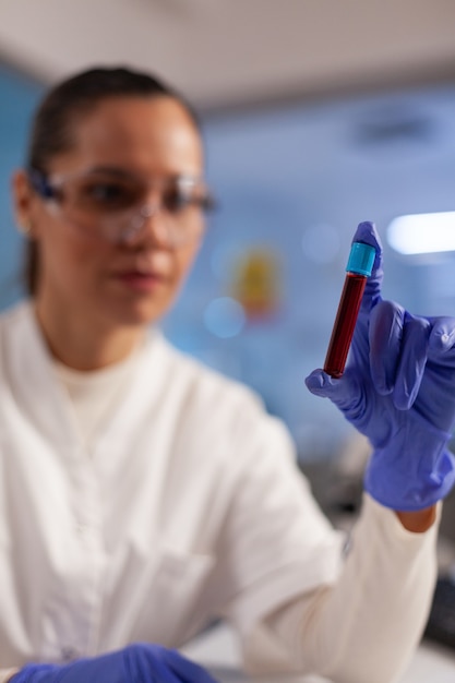 Photo chemical doctor holding blood flask for tests