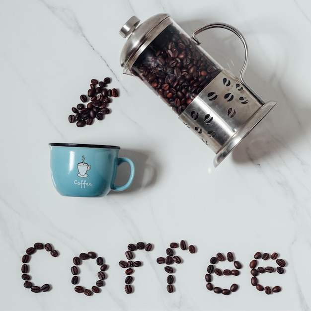 Photo chemical formula of caffeine with roasted coffee spill out of cup on white background