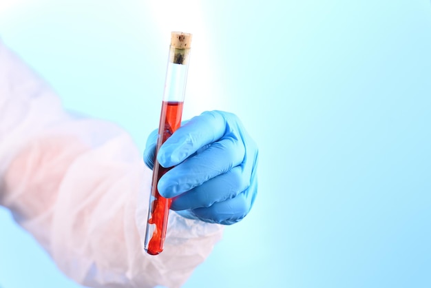 Chemical laboratory preparation in the form of red liquid in a test tube.