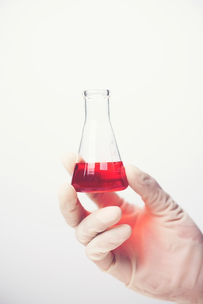 Chemical liquid in glassware of science lab on white background