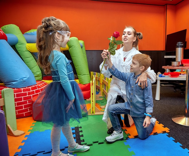 Photo chemical show for kids professor carried out chemical experiments with liquid nitrogen on birthday little girl