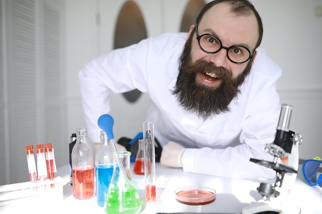 Chemist crazy A mad scientist conducts experiments in a scientific laboratory Performs research using a microscope