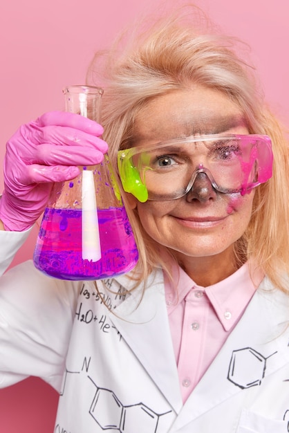  chemist investigates properties of elements analyzes chemical components wears dirty protective eyeglasses performs routine analysis prepares solutions.