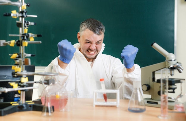 A chemist in the lab is pleased with the result of his experiment to create a new vaccine. Real emotions. Close-up