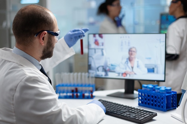 Photo chemist researcher holding medical test tubes analyzing blood expertise