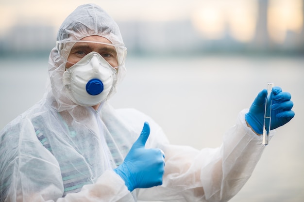 Chemist in respirator with testtube