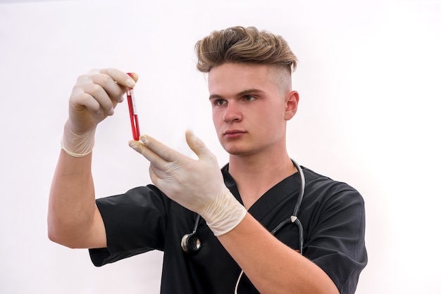 Chemistry and laboratory experiment concept. Man in medical uniform and protective gloves holding red test tube