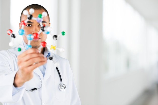 Chemistry male Student holding molecule form isolated on white