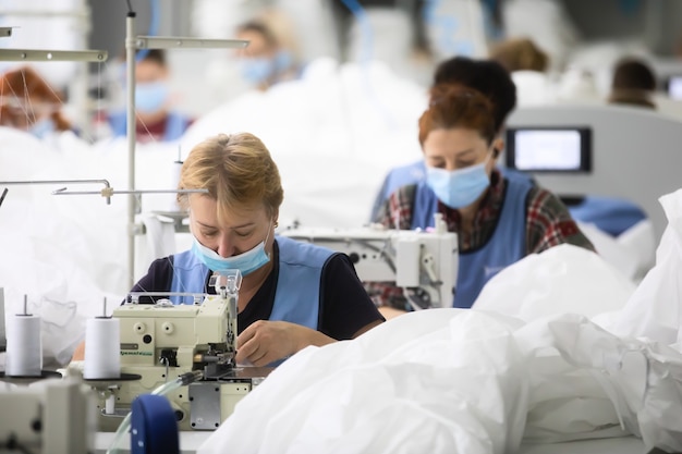 CHERNIGIV, UKRAINE - Oct. 06, 2020: Sewing of protective suits for medics and doctors during covid-19 pandemic in sewing factory TK-Style in Chernigiv, Ukraine