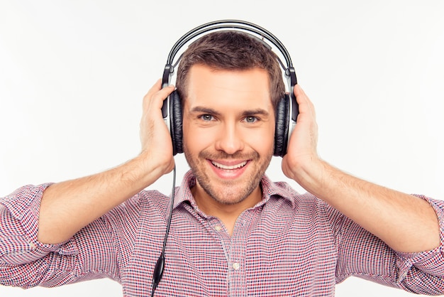 Cherrful man touching his headphones