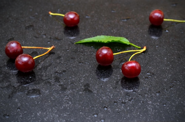 Cherries berries on dark marble background