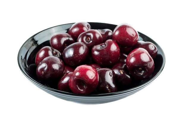 Cherries in a black bowl.