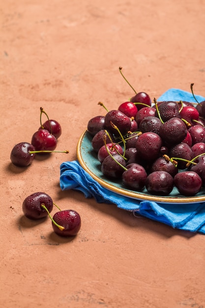 Cherries in a bowl with water drops