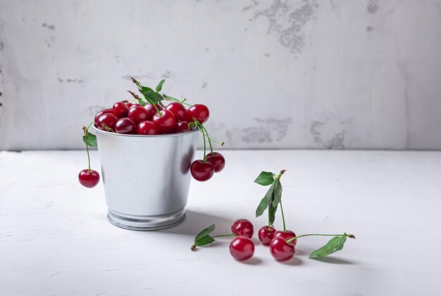 Cherries in a bucket on white background