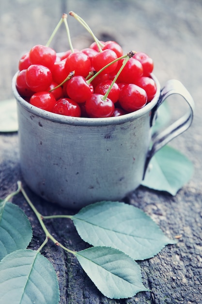 Cherries in an old metal mug