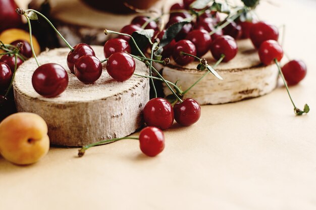 Cherries on wooden stumps