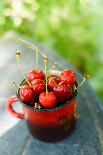 Cherries on wooden table with water drops summer macro background