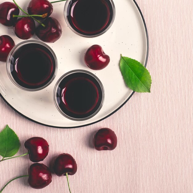 Cherry alcohol drink liquor or brandy on a pink background