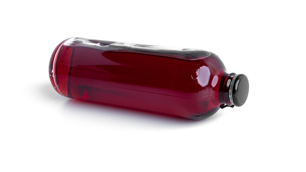 Cherry alcoholic drink in a bottle isolated on white.