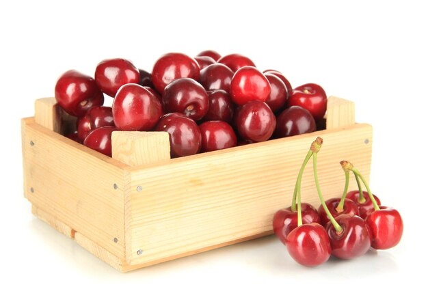 Cherry berries in wooden box isolated on white