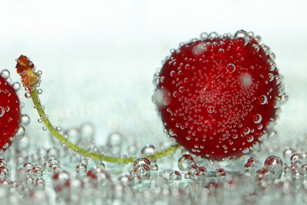 Cherry blossom in gas bubbles on a light blurred 