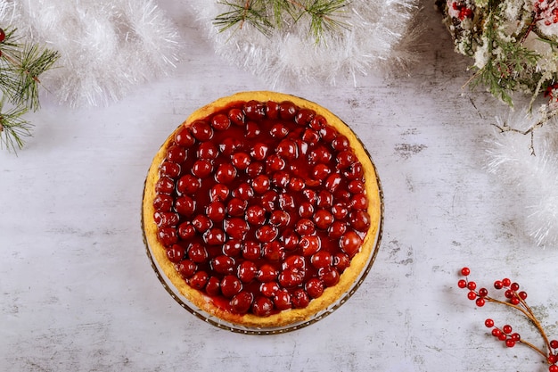 Cherry cheesecake with berries on the top with cristmas decoration