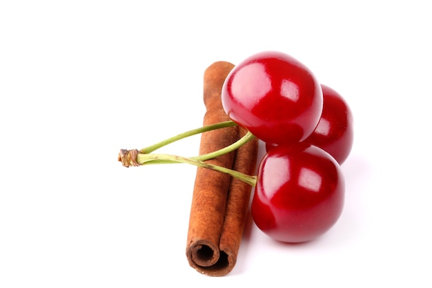 Cherry and cinnamon isolated on white background