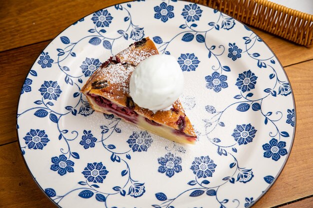 Cherry Clafoutis with ice cream on a plate