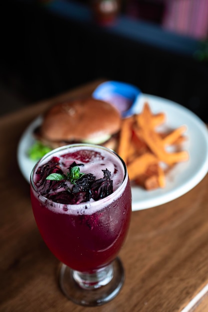 Cherry cocktail accompanied by a plate of food