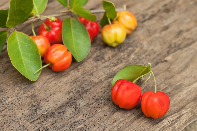 Cherry fruit on the wooden background.