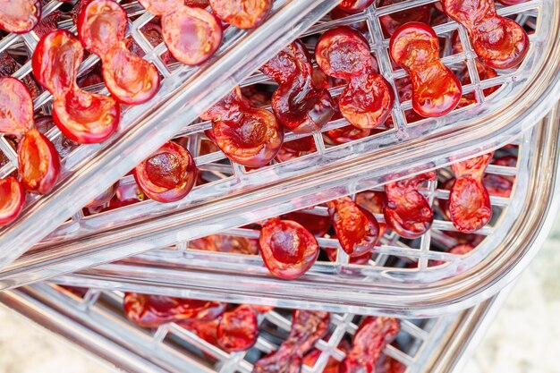 Cherry halves on dehydrator tray