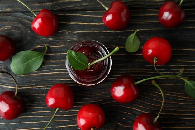 Cherry jam and ingredients on rustic wooden table