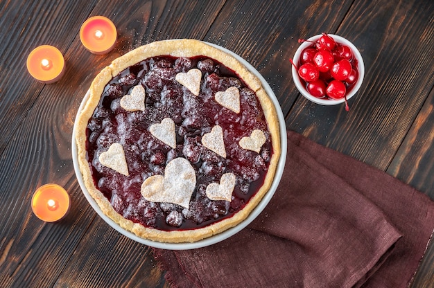 Cherry jam tart decorated with hearts, top view