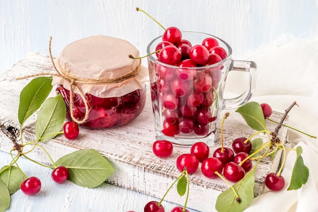 Cherry jam with fresh cherries on a white background