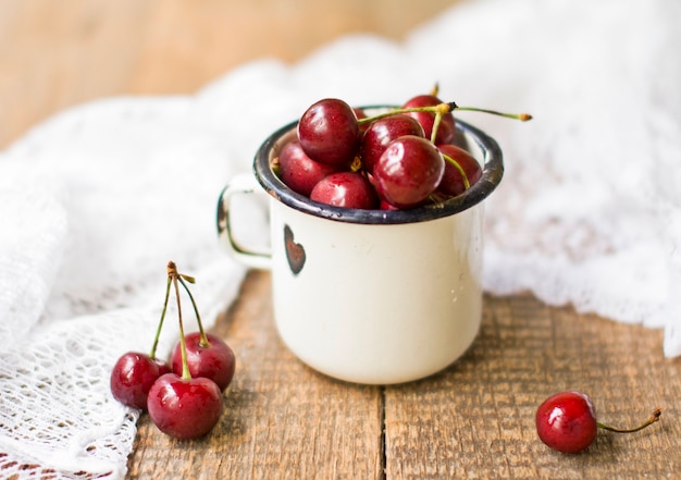 Cherry in metal ware with a cloth. Close up, selective focus