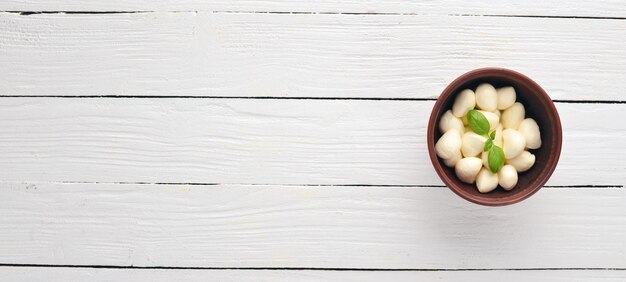 Cherry mozzarella cheese Top view On a white wooden background Free copy space