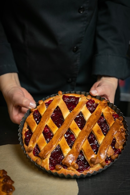 Cherry pie on a brown wooden table