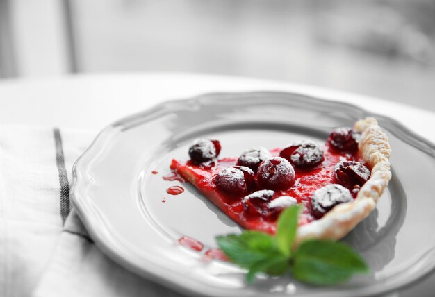 Cherry pie slice on gray plate close up