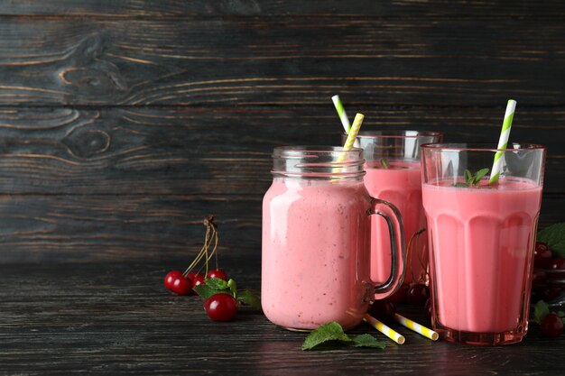 Cherry smoothie and ingredients on rustic wooden table