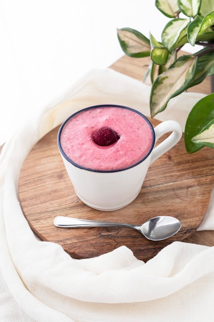 Cherry smoothie in a white ceramic mug