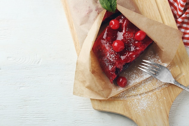 Cherry strudel with mint and fork on cutting board