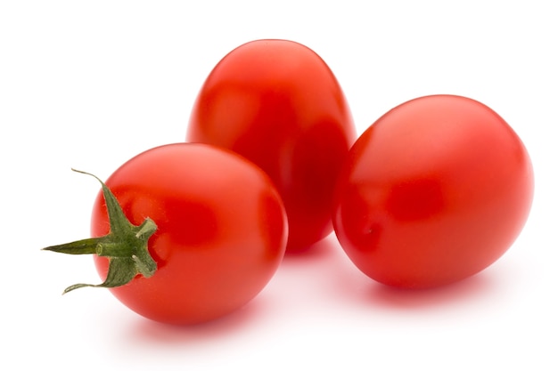 Cherry-tomaten. Drie kerstomaatjes op een witte achtergrond.